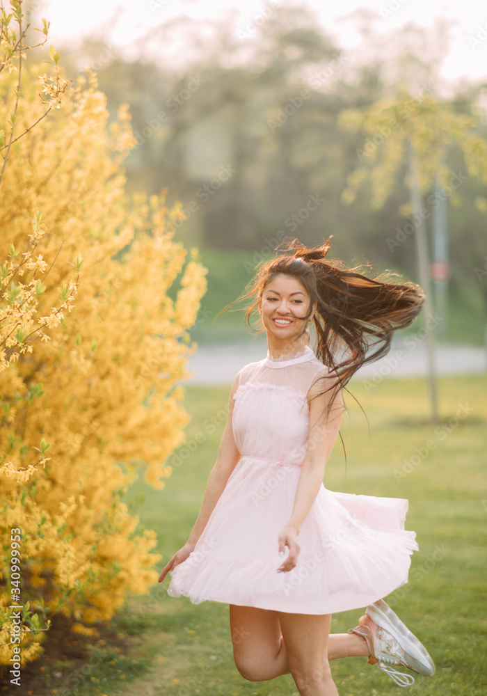 Young woman has enjoy and relaxes near blooming forsythia bushes. Young woman has enjoy and relaxes near blooming forsythia bushes.