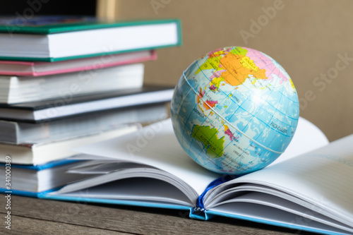 Books and textbook on wooden desk in library, Piles of books on reading desk in school with copy space for text.World book day and education concept. © MemoryMan