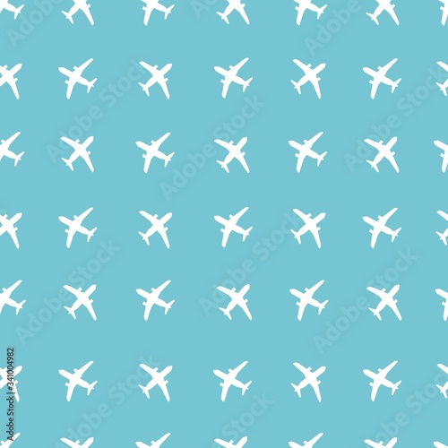 Seamless vector pattern. Airplane of white color isolated on a blue background. Vector graphics.