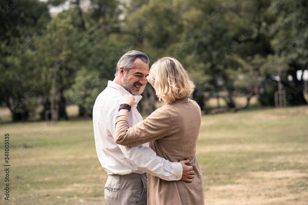 Lifestyle, senior elderly retirement couple dancing together in park. Old man holding woman hip and dance with happiness. Grandparent feels happy with smile face. Enjoy relax time on vacation holiday. Lifestyle, senior elderly retirement couple dancing together in park. Old man holding woman hip and dance with happiness. Grandparent feels happy with smile face. Enjoy relax time on vacation holiday.