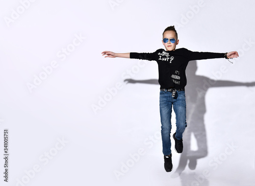 Young boy jumping isolated over white background