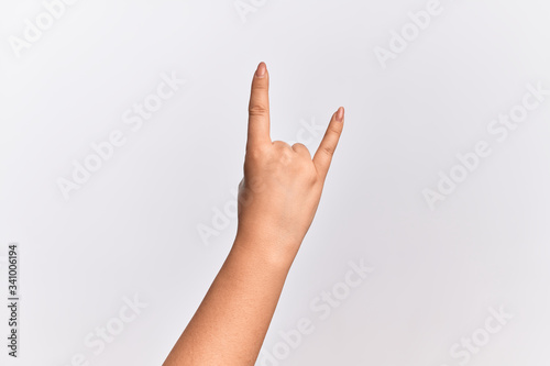 Hand of caucasian young woman gesturing rock and roll symbol, showing obscene horns gesture