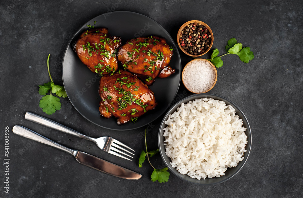 grilled sweet chicken thighs and  cooked rice on a stone background. Asian food