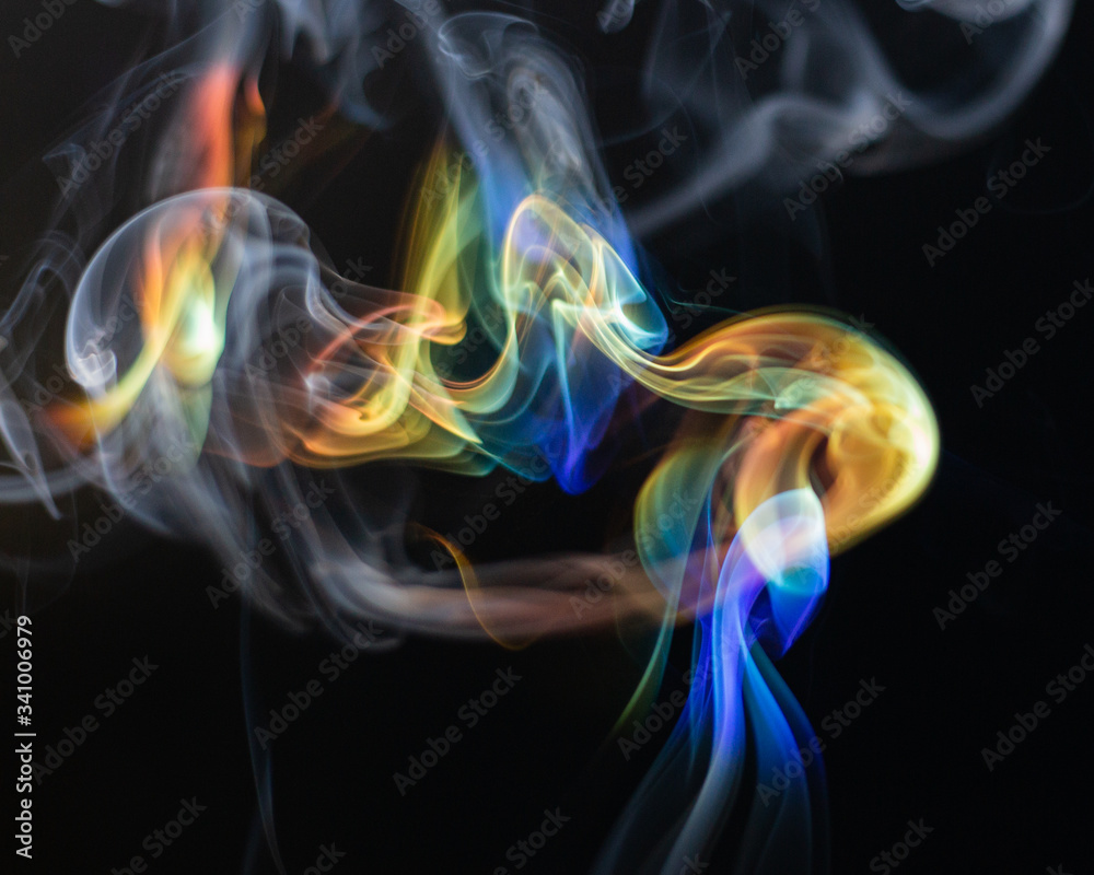 Rainbow colored smoke on a black background Rainbow colored smoke on a black background