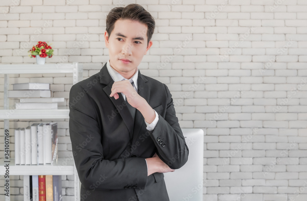 Portrait of asian handsome young businessman in suit standing posing Portrait of asian handsome young businessman in suit standing posing