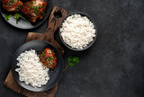 grilled sweet chicken thighs and  cooked rice on a stone background 
with copy space for your text. Asian food