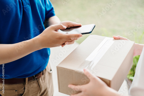 Door to door delivery express sending send a package to customer receiver sign with smartphone checking shipping deliver cargo social distancing reduce touch while the virus is spreading, Coronavirus.