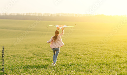 Cute girl flying bright kite