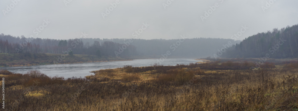 Photography of Russian country side in rainy day. Autumn landscape. Famous Volga river in Tver region. Concepts of travel and touristic mood and beauty of nature in bad wet weather.