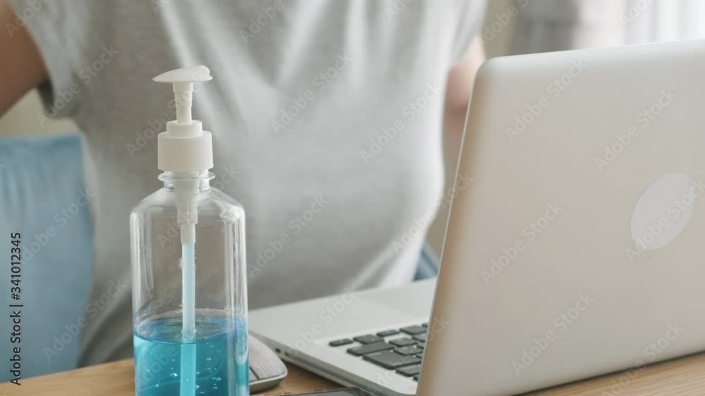 Asian young woman work from home to avoid close contact with people who are unwell. Girl always use hand sanitizer gel for clean hands often to prevent coronavirus infection. Covid-19 Social distance. Asian young woman work from home to avoid close contact with people who are unwell. Girl always use hand sanitizer gel for clean hands often to prevent coronavirus infection. Covid-19 Social distance.