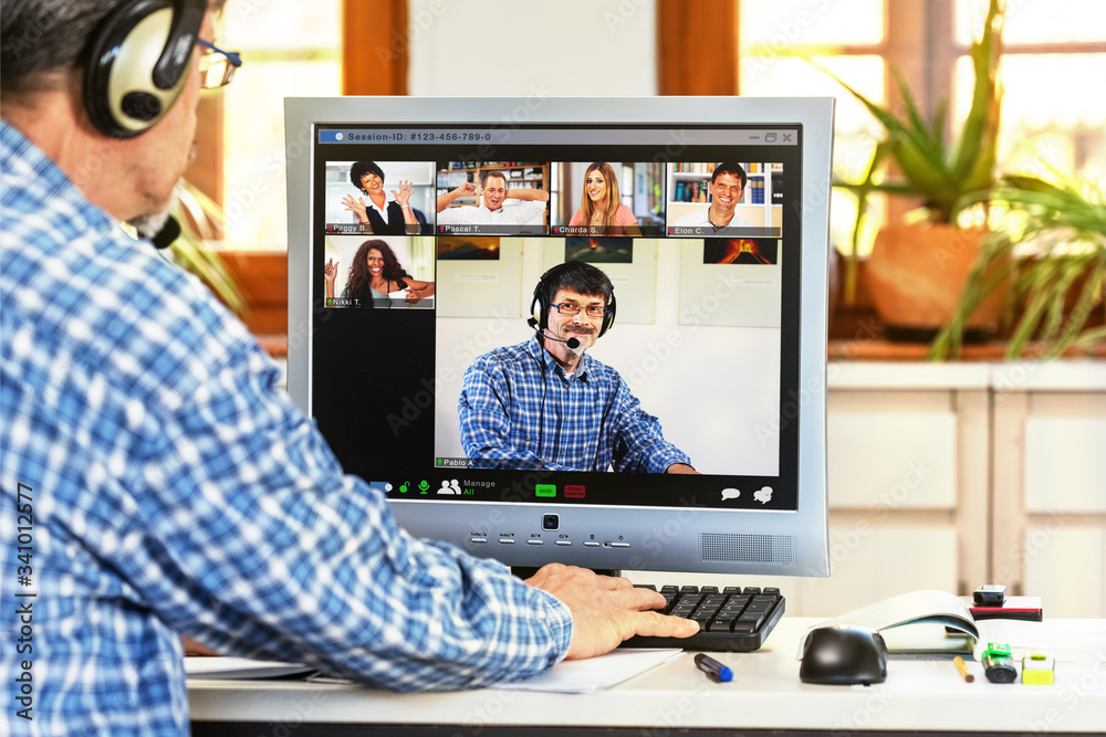 A computer screen in a home office showing a group of people and the tutor having fun with E-learning A computer screen in a home office showing a group of people and the tutor having fun with E-learning