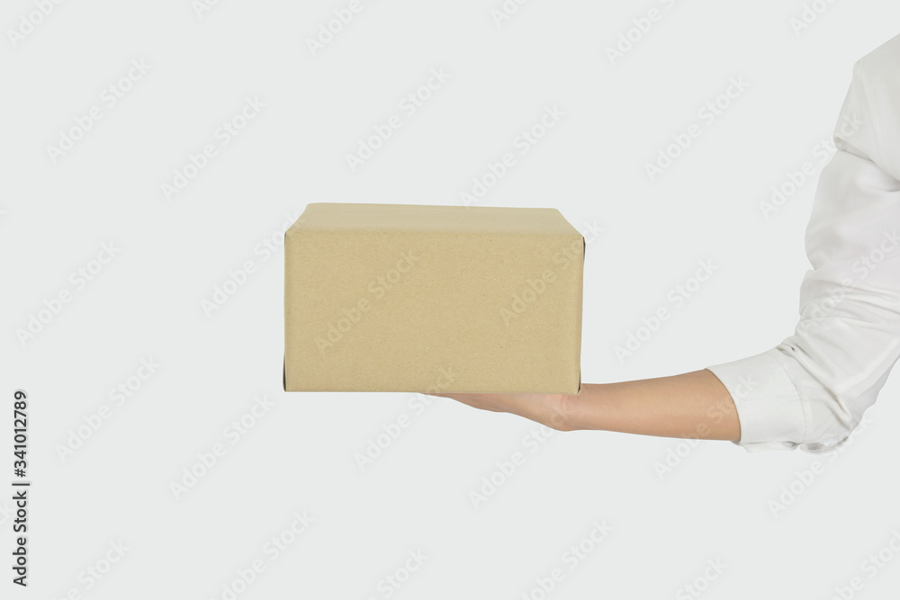 Female hands holding box isolated on grey background. Female hands holding box isolated on grey background.