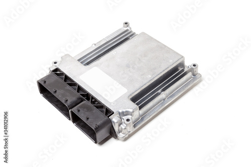 Plastic car engine control unit with metal elements on a white isolated background is the connecting center of various subsystems, units and assemblies. Monitoring the state of the moment. Spare part photo