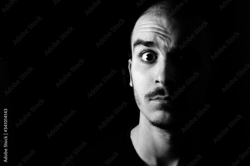 Portrait of a guy with moustache looking confused