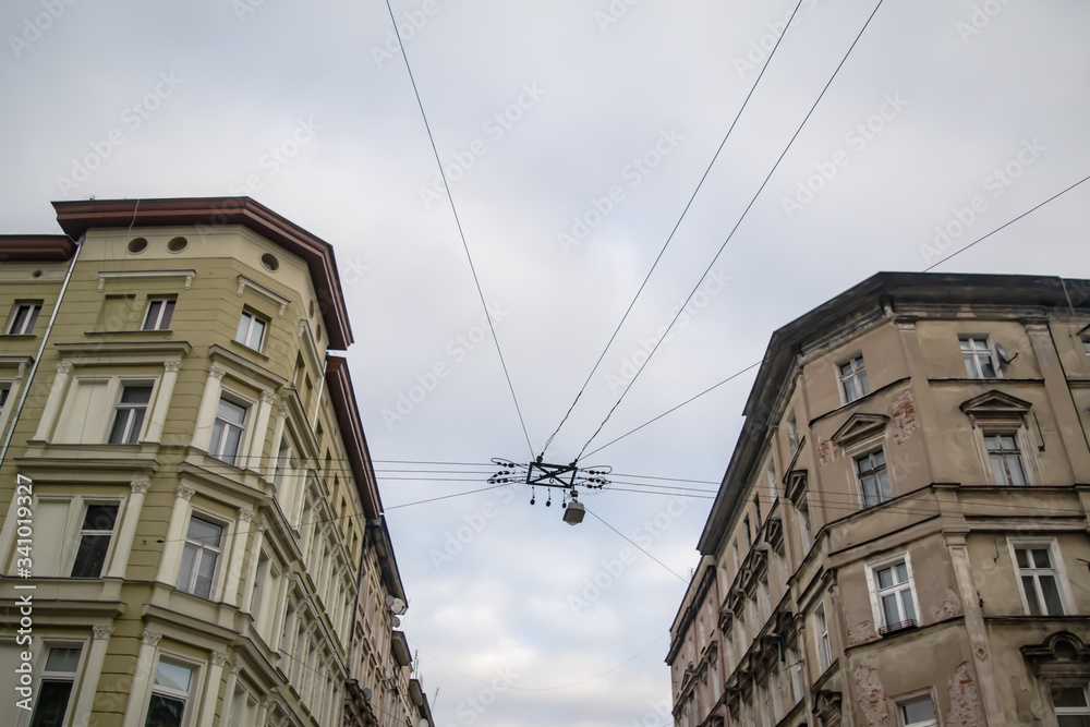 Perspective of a cross street in Wroclaw, Poland with contrast between new and old buildings and wire with street light. Perspective of a cross street in Wroclaw, Poland with contrast between new and old buildings and wire with street light.