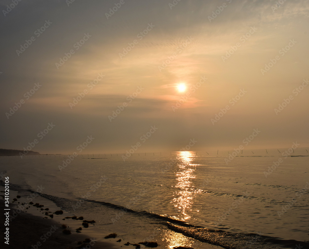 Nice sunrise in the ocean ,while seeing it from the beach,a very calm situation