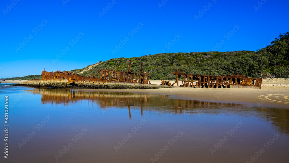 Obraz premium Colourful Maheno Wreck view from low tide on Fraser Island, Queensland, Australia
