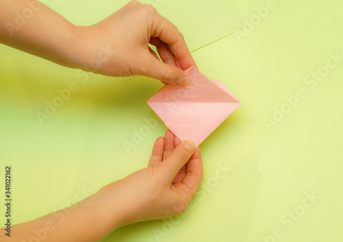 Origami pink heart on a green background, step by step instructions. as great idea for a hand made diy Valentine s Day, Mothers day gift. Step 20
