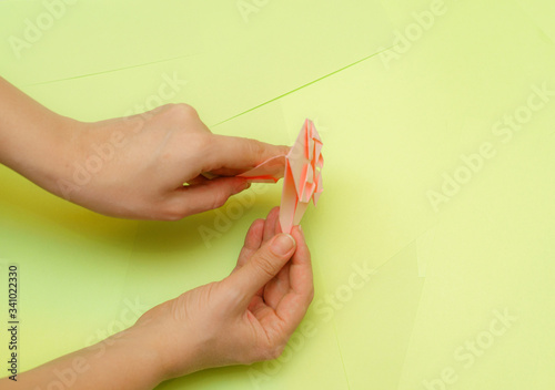 Origami pink heart on a green background, step by step instructions. as great idea for a hand made diy Valentine s Day, Mothers day gift. Step 22