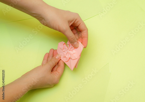 Origami pink heart on a green background, step by step instructions. as great idea for a hand made diy Valentine s Day, Mothers day gift. Step 24