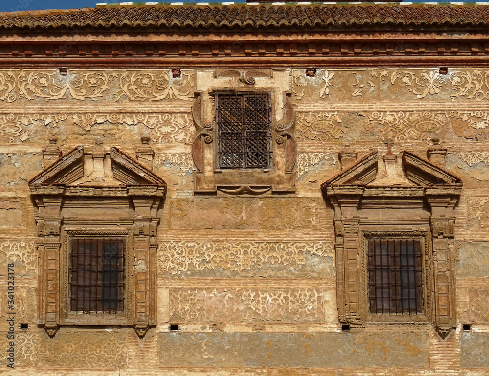 Windows and old plaster decoration of baroque façade. Concepcionistas Monastery in the old city center of Guadix. Spain. 
