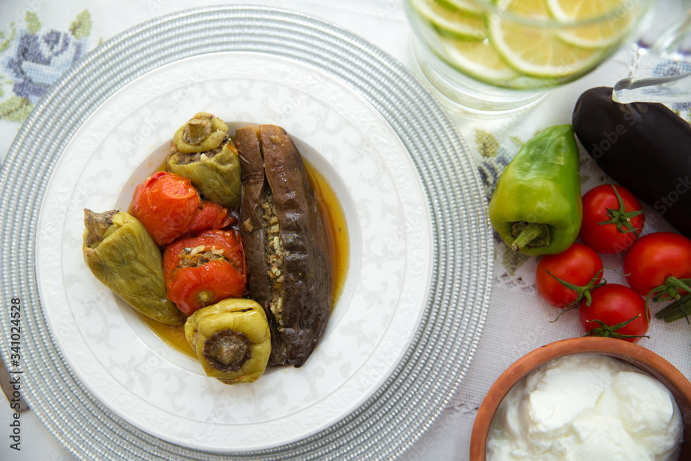 Eggplants are stuffed with meat lamb and rice. Patlican . eggplant filling . Eggplant, peppers, tomatoes . Yogurt in a brown bowl . Chopped lemon in a glass jar . Stuffed eggplant in the plate . Eggplants are stuffed with meat lamb and rice. Patlican . eggplant filling . Eggplant, peppers, tomatoes . Yogurt in a brown bowl . Chopped lemon in a glass jar . Stuffed eggplant in the plate .