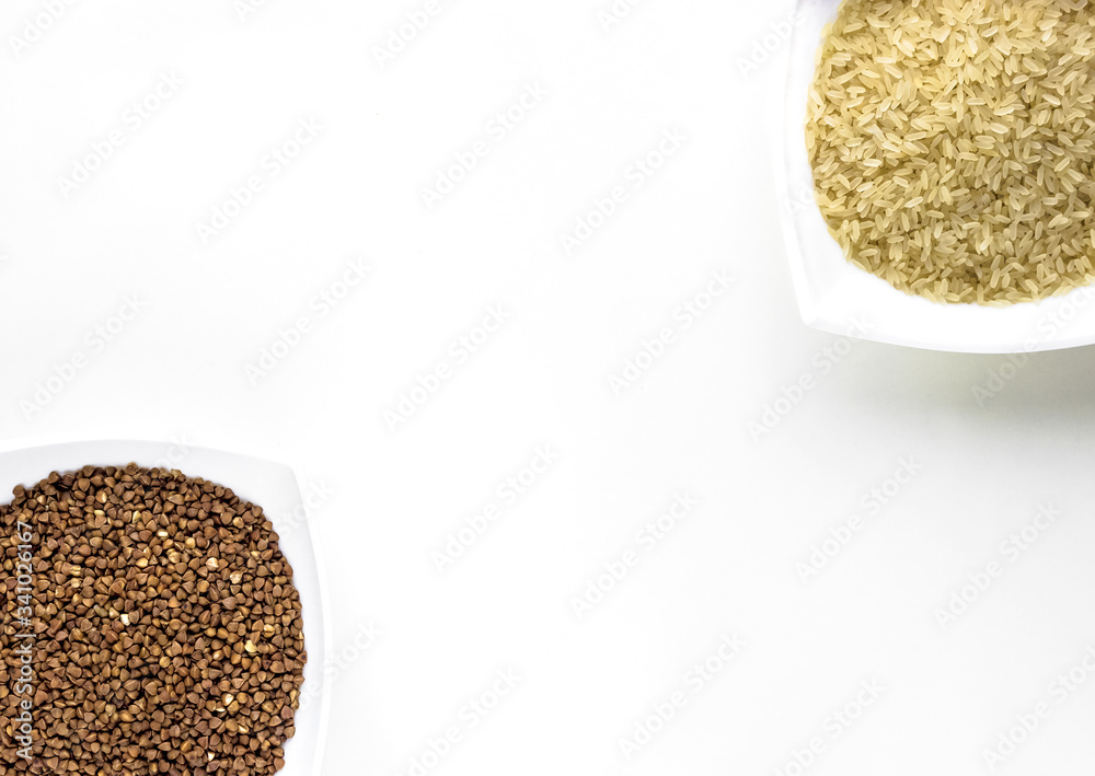 close up of white cups of buckwheat and rice layout on white isolated background. asian food and kitchen concept close up of white cups of buckwheat and rice layout on white isolated background. asian food and kitchen concept