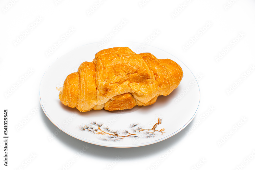 Croissants set on a plate, on a white background. Chocolate pastry waiting to be eaten. Croissants set on a plate, on a white background. Chocolate pastry waiting to be eaten.