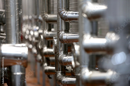 shiny metal pipes in a brewery