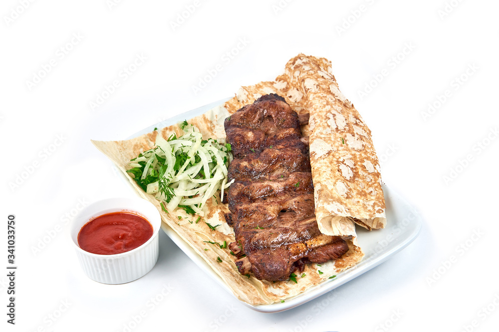 Pork ribs skewers on the bone with sauce in a restaurant close-up Pork ribs skewers on the bone with sauce in a restaurant close-up