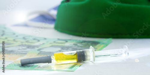 100 Australian dollars, Green mask syringe economic crisis Health expenses Corona virus outbreak. The idea is to spend a lot of money on inventing vaccines to prevent epidemics..