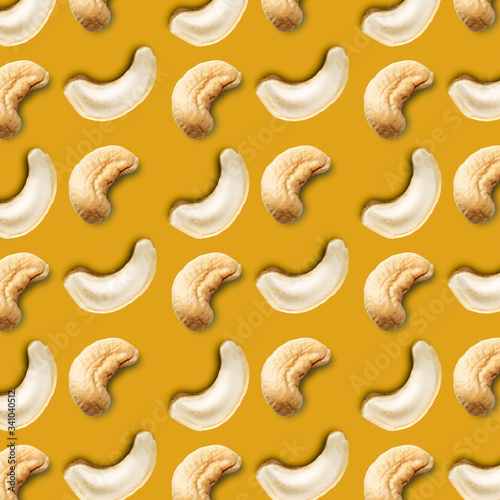Seamless pattern of cashew nuts on a gold background. Food pattern of cashew nuts on a yellow background. Food pattern.