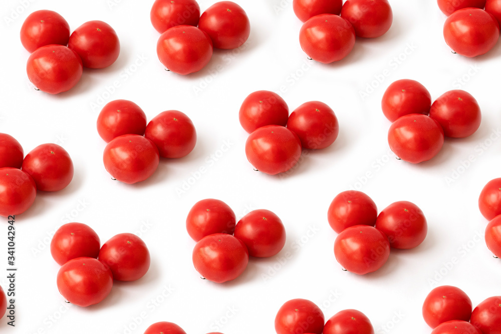Modern minimalistic natural pattern, pink tomatoes on a white background. Summer and autumn concept. Flat lay. Modern minimalistic natural pattern, pink tomatoes on a white background. Summer and autumn concept. Flat lay.