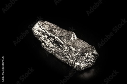 tin stone on black isolated background. Industrial application ore.