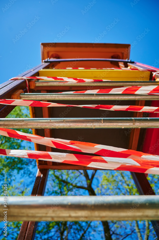 Children's playground in Berlin, Germany, which was closed due to the Covid-19 virus and the blocking of contact with a barrier tape. Children's playground in Berlin, Germany, which was closed due to the Covid-19 virus and the blocking of contact with a barrier tape.