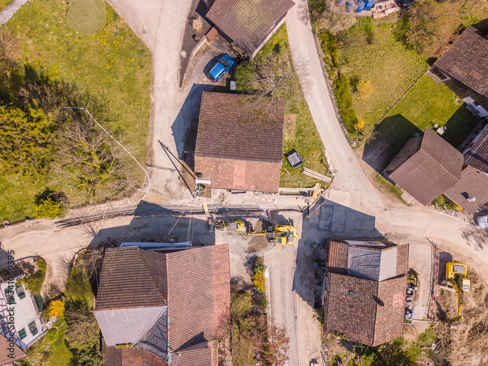 Aerial view of road renewal and underground cable construction works in rural area in Switzerland