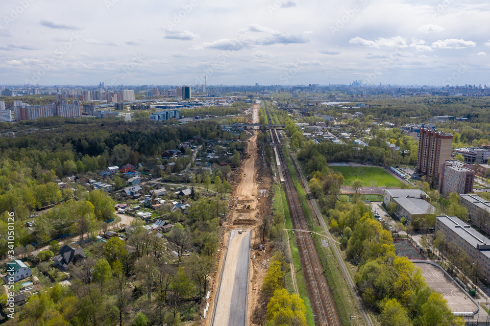 Aerial view of building a new road process along the railway in Moscow
