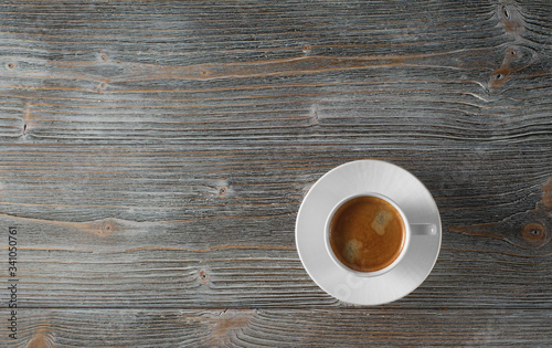 White coffee cup on a wooden table, flat lay. Old wooden table.