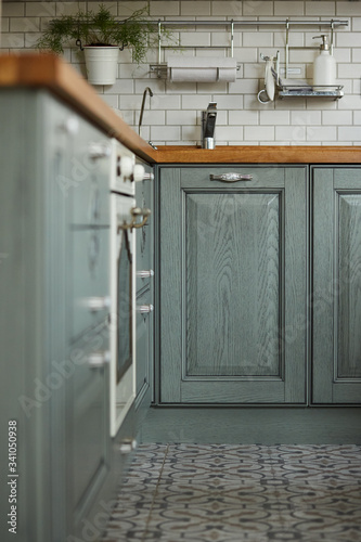 A view of a green wooden kitchen