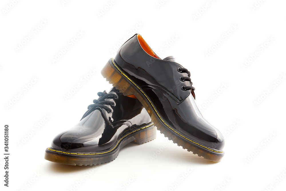 Black shiny leather shoes for woman. Female fashion footwear on white background. Formal trendy oxford boots.