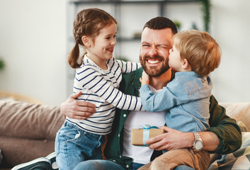 Happy father getting congratulations from kids.