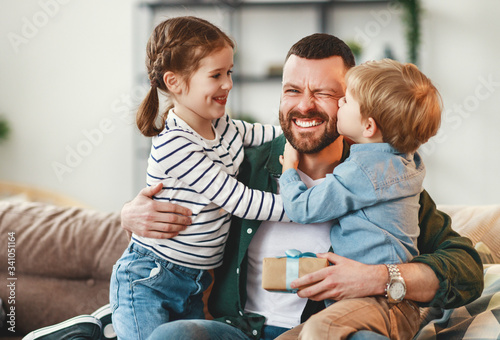 Happy father getting congratulations from kids. photo