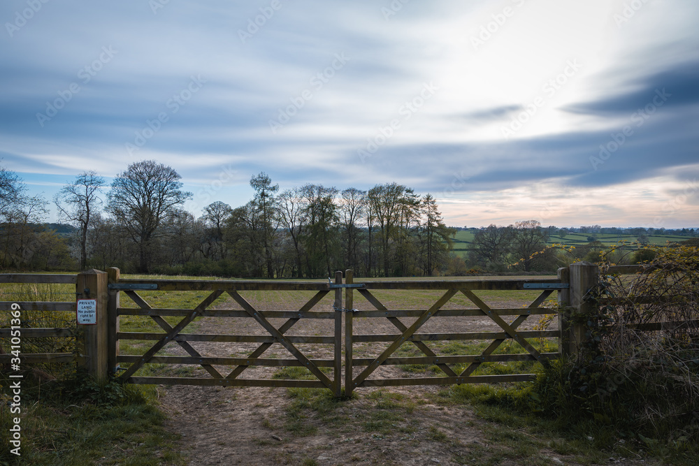 Old Rustic Farm Gate in front of a beautiful landscape of the  Yorkshire countryside at dusk