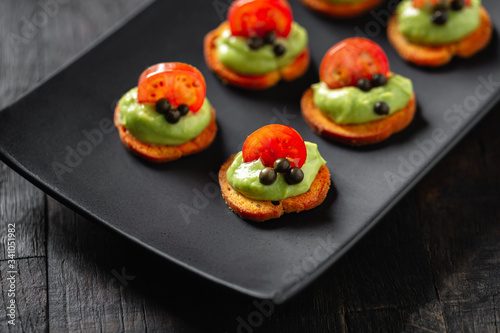 mini catering canapes with guacamole and cherry tomato