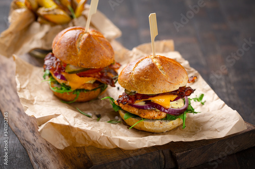 tasty looking homemade chicken burgers with cheese and bacon