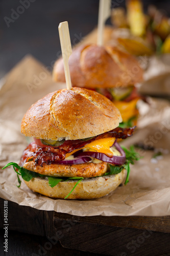 tasty looking homemade chicken burgers with cheese and bacon