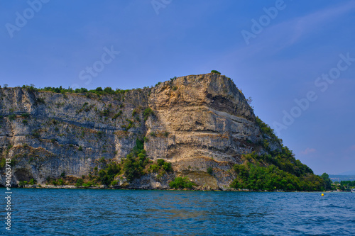 Rocks on lake Garda overhanging the water summer season