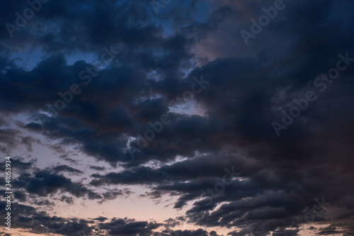 Sunrise on a background of dark gray clouds