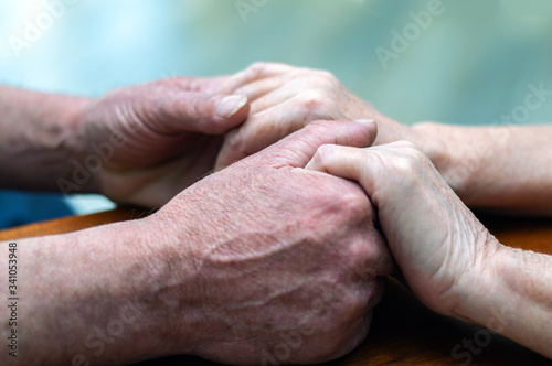 senior family couple holding old hands, psychological support concept