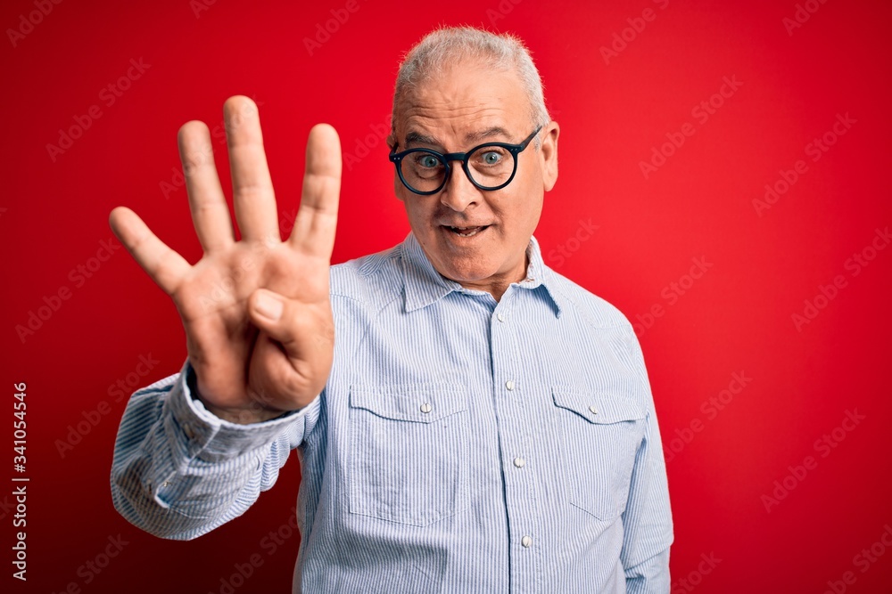 Middle age handsome hoary man wearing casual striped shirt and glasses over red background showing and pointing up with fingers number four while smiling confident and happy. Middle age handsome hoary man wearing casual striped shirt and glasses over red background showing and pointing up with fingers number four while smiling confident and happy.